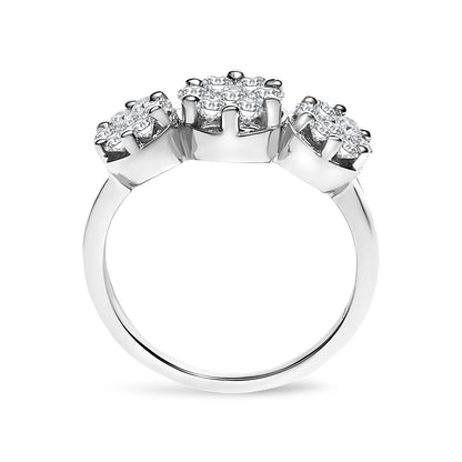 White metal ring with three clusters of round white gemstones in prong settings, shown from a front angle.