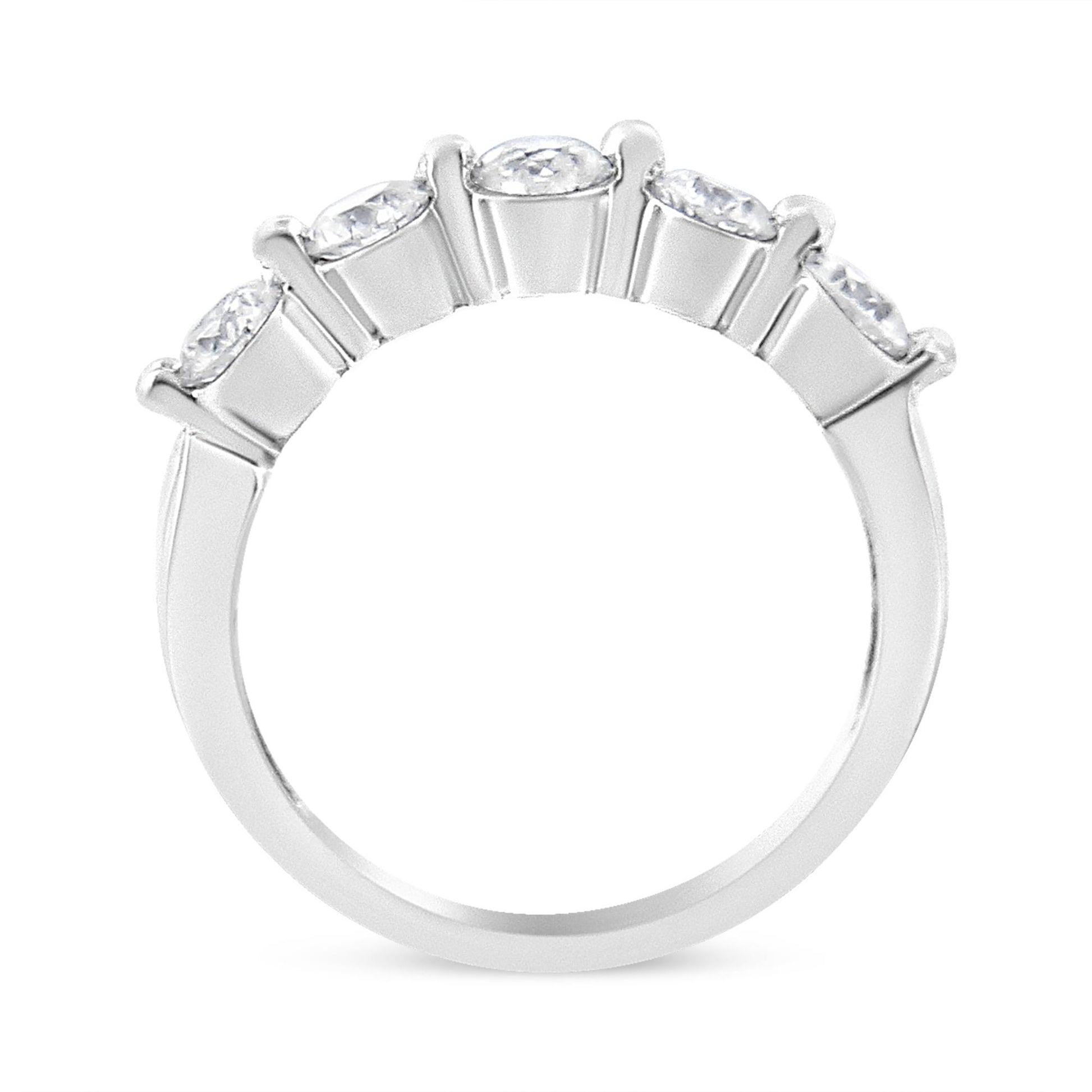 Close-up side angle of white metal ring with five round white gemstones set in a row with a pave setting.