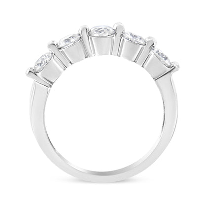 Close-up side angle of white metal ring with five round white gemstones set in a row with a pave setting.