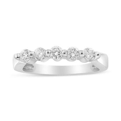 White metal ring with five round white gemstones in a pave setting, shown from a front angle.