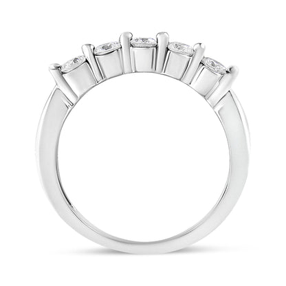 White metal ring with five round white gemstones in a pave setting, shown from a front angle.