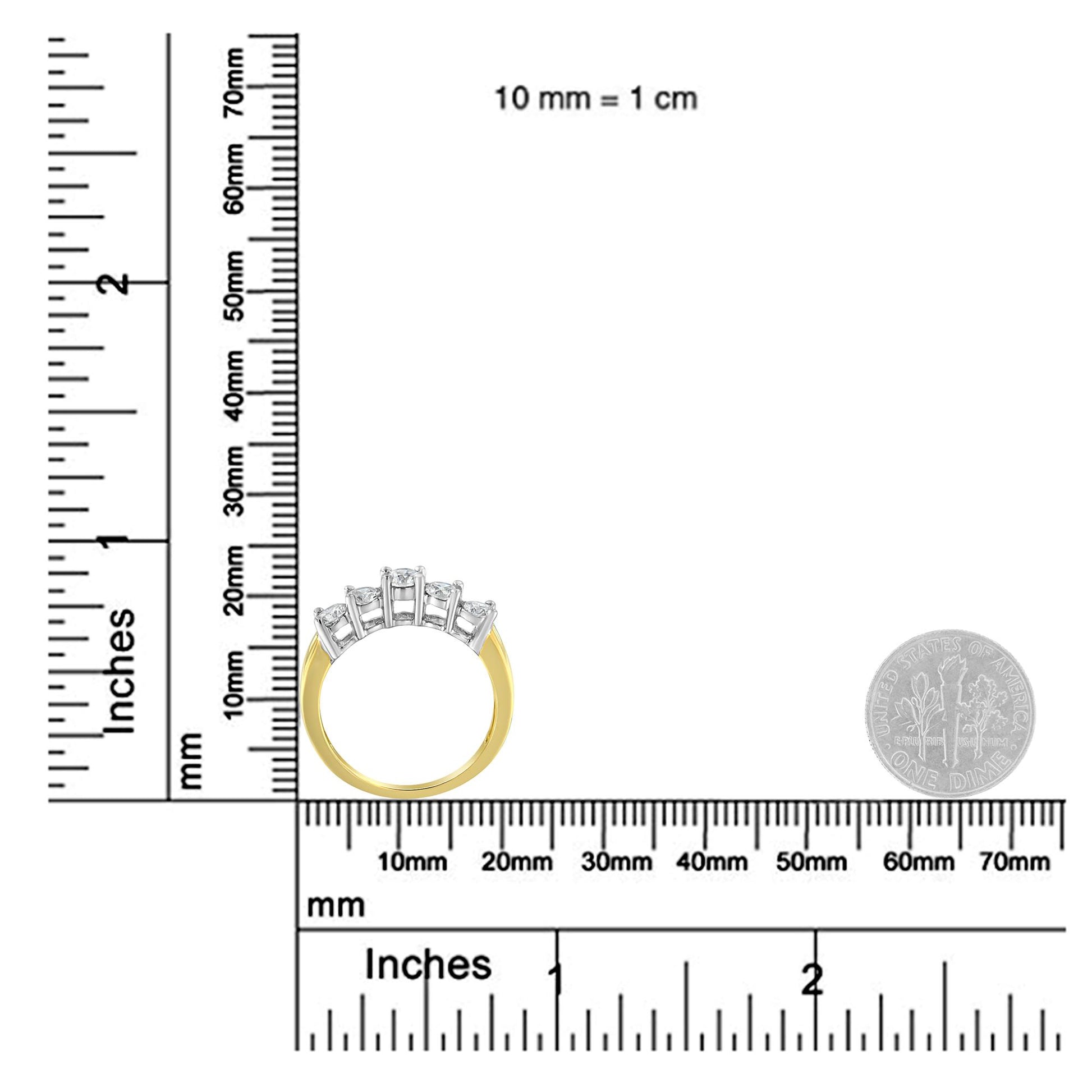 Ring with five round white gemstones in prong settings, yellow and white metal, shown from side angle on a ruler for size reference.