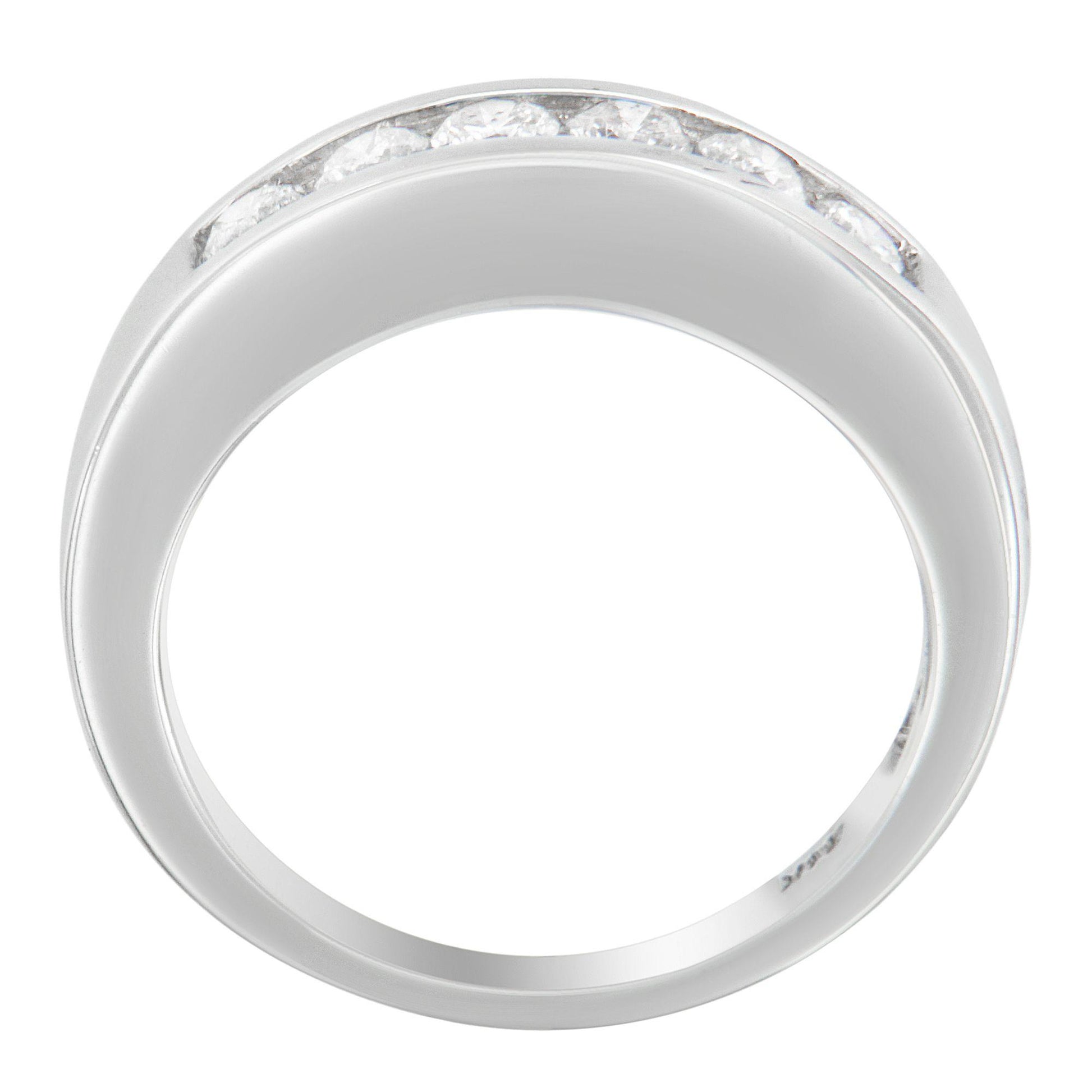 White metal ring with a channel setting of round white gemstones, viewed from above.