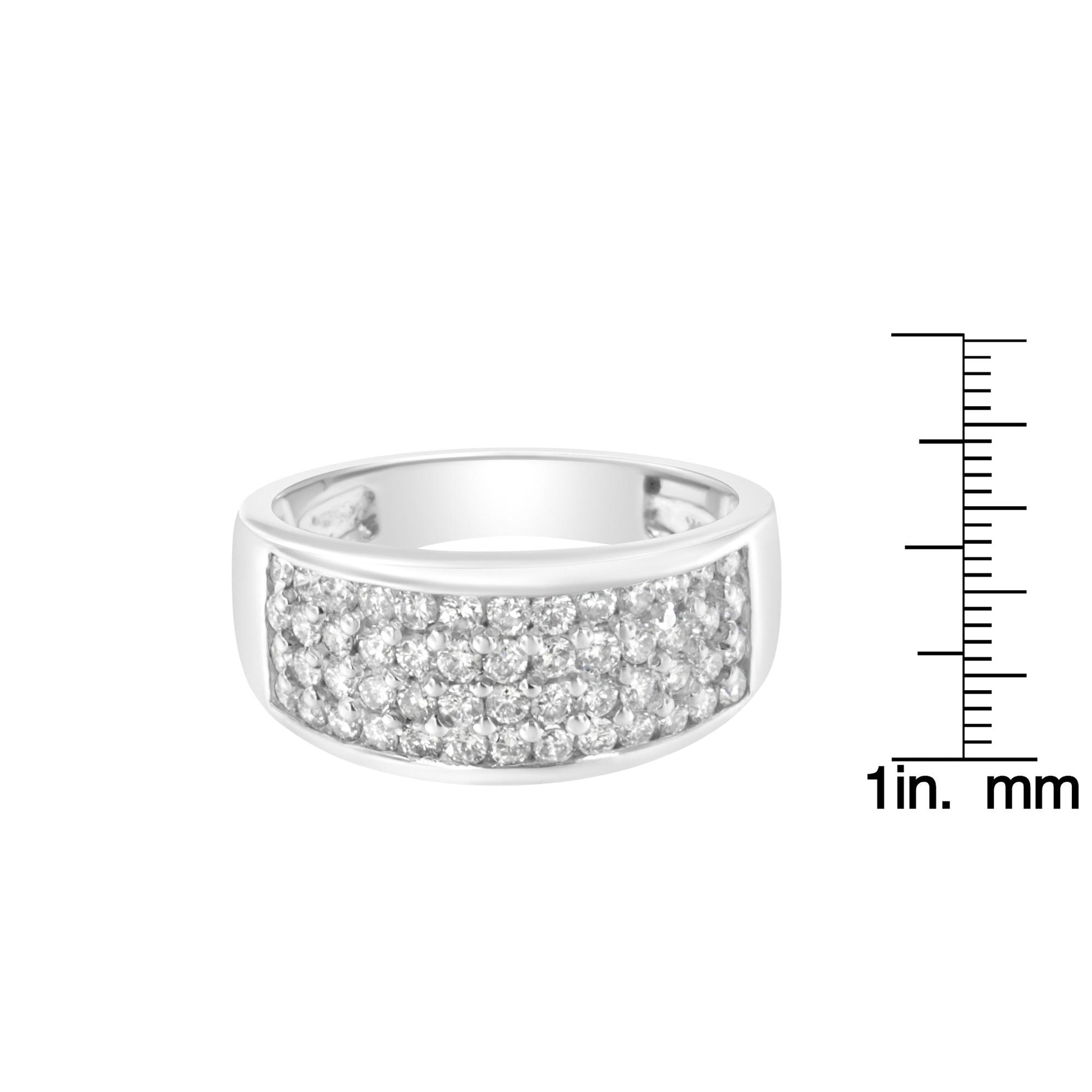 White metal ring with a wide band featuring multiple round white gemstones in a pave setting, shown from a slightly angled front view, positioned next to a ruler for size reference.