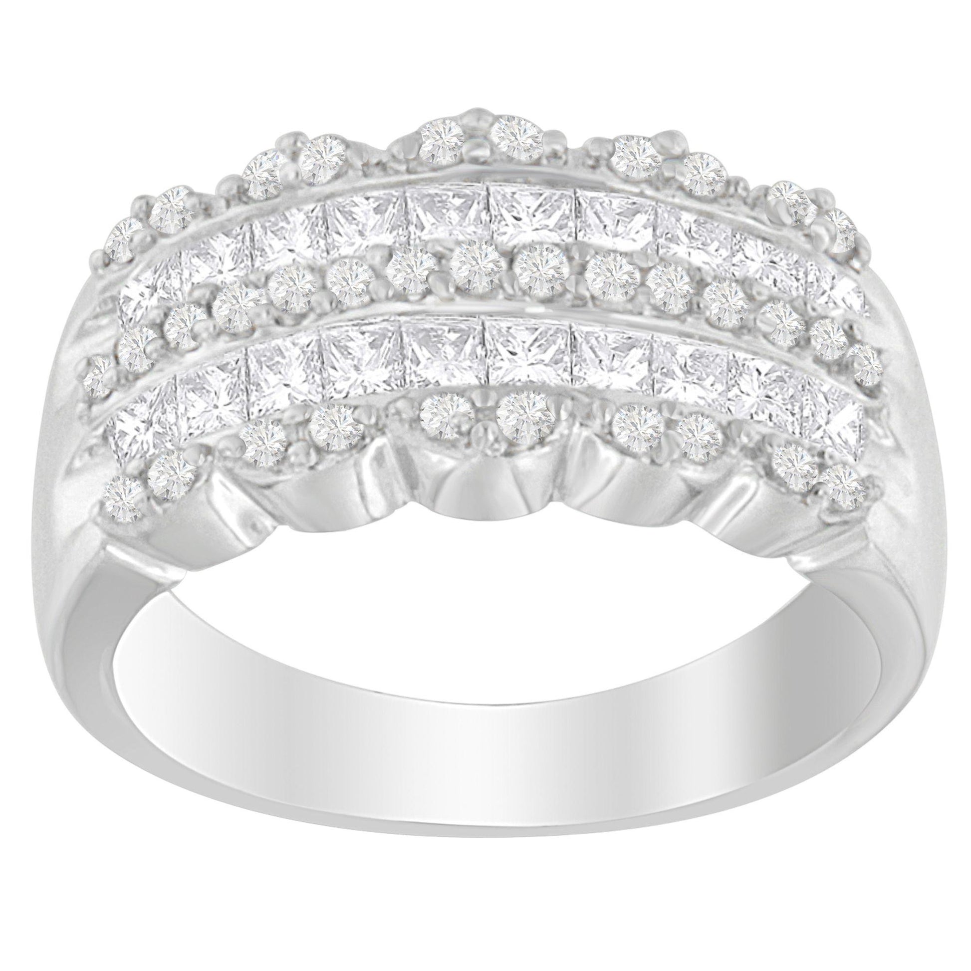 Front-facing close-up of a white metal ring featuring rows of round pave-set white gemstones above a row of princess shape invisible-set white gemstones.
