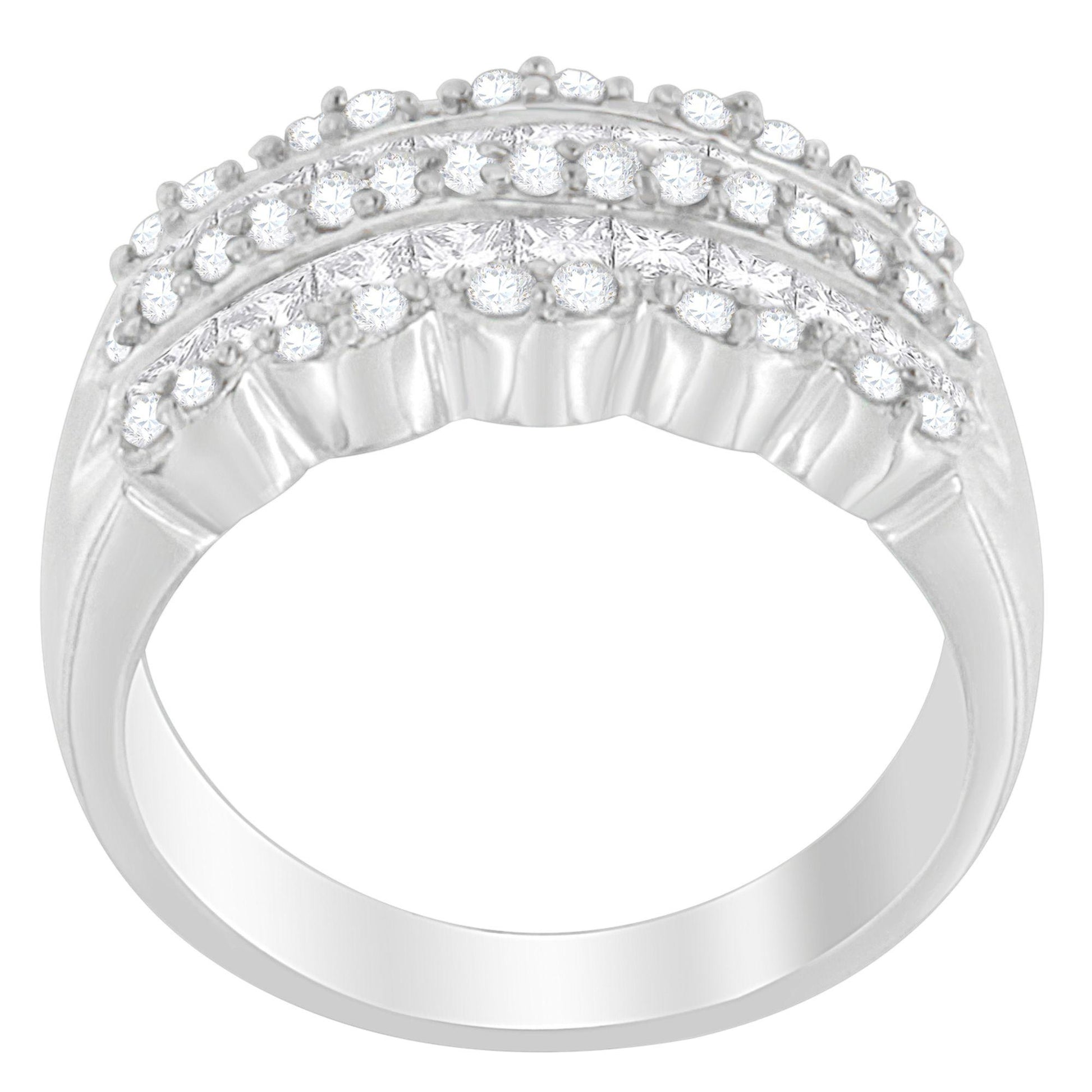 White metal ring with rows of round and princess-shaped white gemstones, side angled view.
