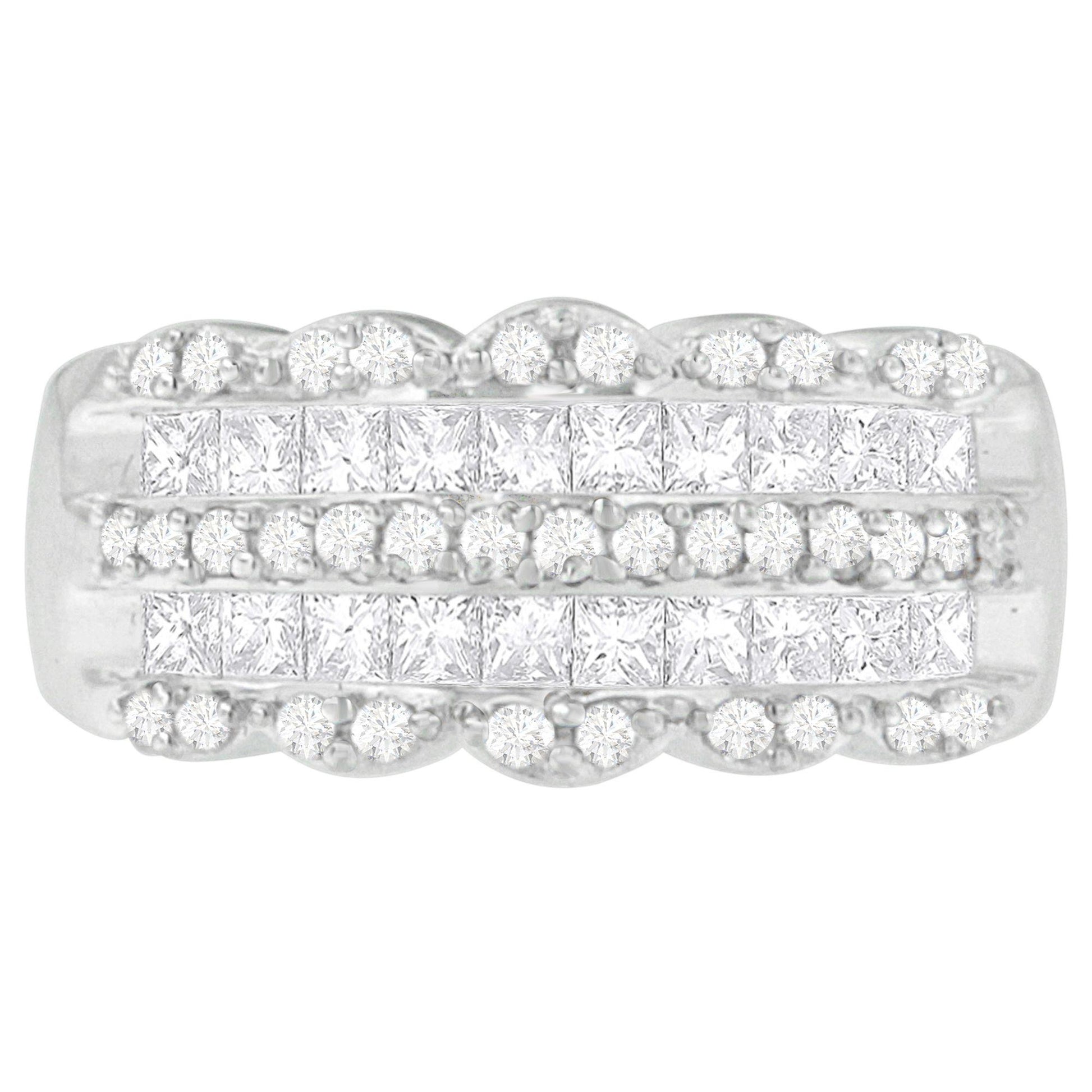 Top-down close-up of a white ring featuring rows of round white gemstones in pave settings and princess-shaped white gemstones in invisible settings.