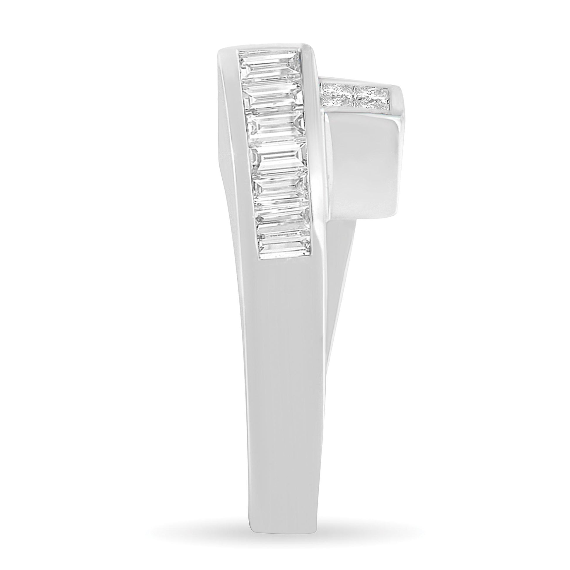 Side view of a white metal ring featuring vertically set baguette-shaped white gemstones in a channel setting and princess-shaped white gemstones in an invisible setting on the upper side.