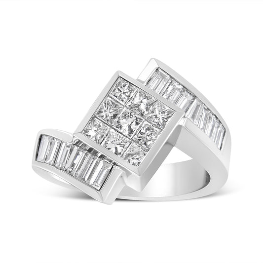 White metal ring with a large square cluster of princess cut white gemstones in invisible setting, flanked by two rows of baguette cut white gemstones in channel setting, photographed from a slightly angled side view.