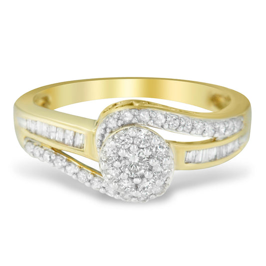 Yellow metal ring with a round cluster of white gemstones at the center, accented by curved rows of round white gemstones and straight rows of baguette white gemstones, shown in a close-up front angle.