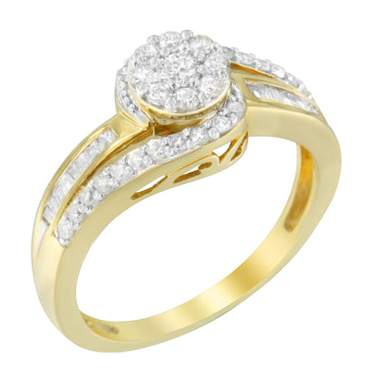 Yellow metal ring with a round cluster of white gemstones on top, surrounded by additional round and baguette white gemstones along the band, shown from a tilted angle.