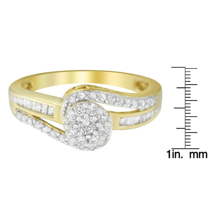 Yellow metal ring with a centered cluster of round white gemstones in prong settings, accented by curved rows of round white gemstones and straight rows of baguette white gemstones in channel settings, shown from a front angle on a ruler for size reference.