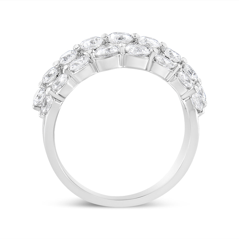 White metal ring with round white gemstones in 2-prong settings, shown in a side profile angle.