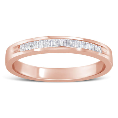 Close-up front view of a rose-colored ring with a channel set row of white baguette-shaped gemstones.