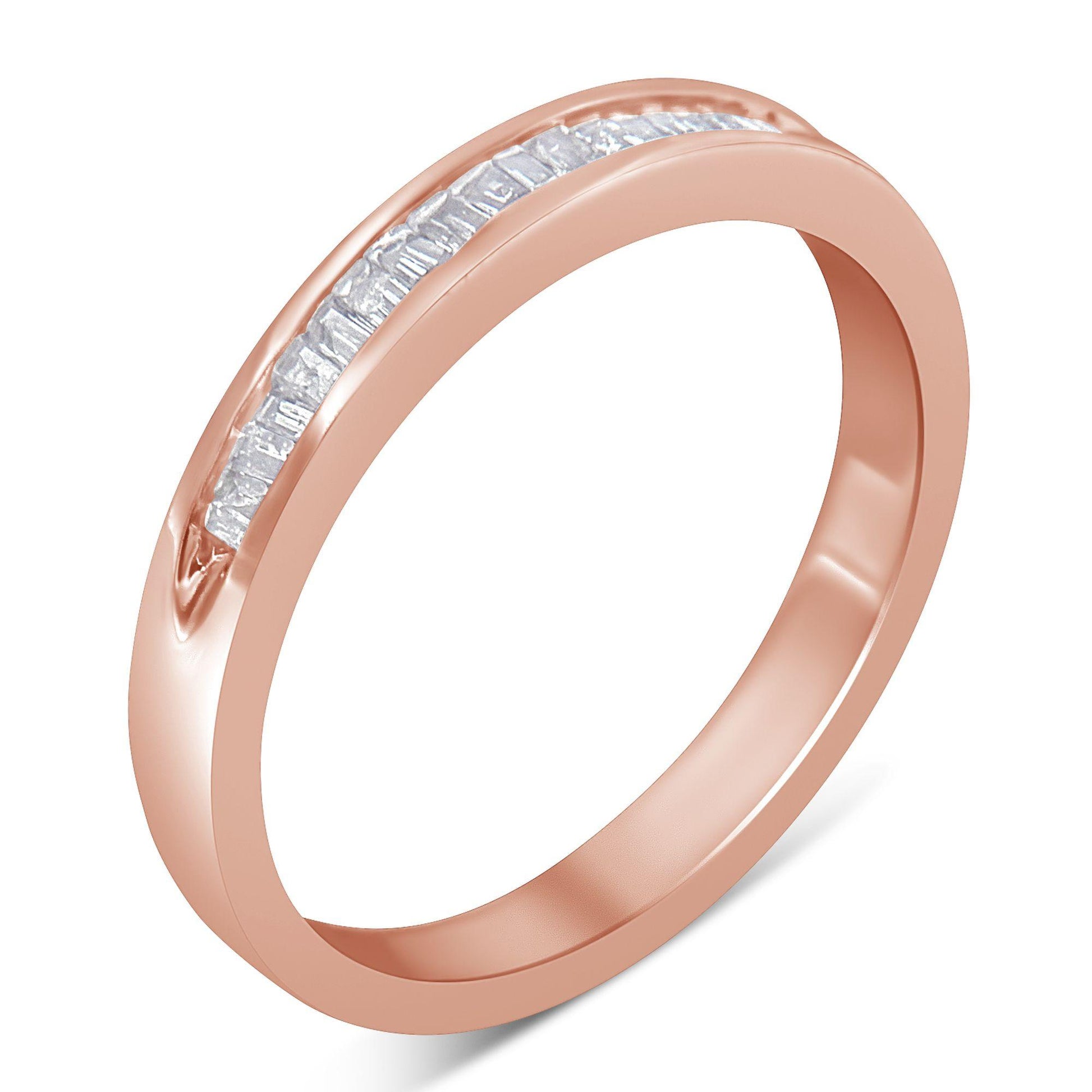 Rose-colored ring with a channel set row of white baguette-shaped gemstones, shown at an angle.