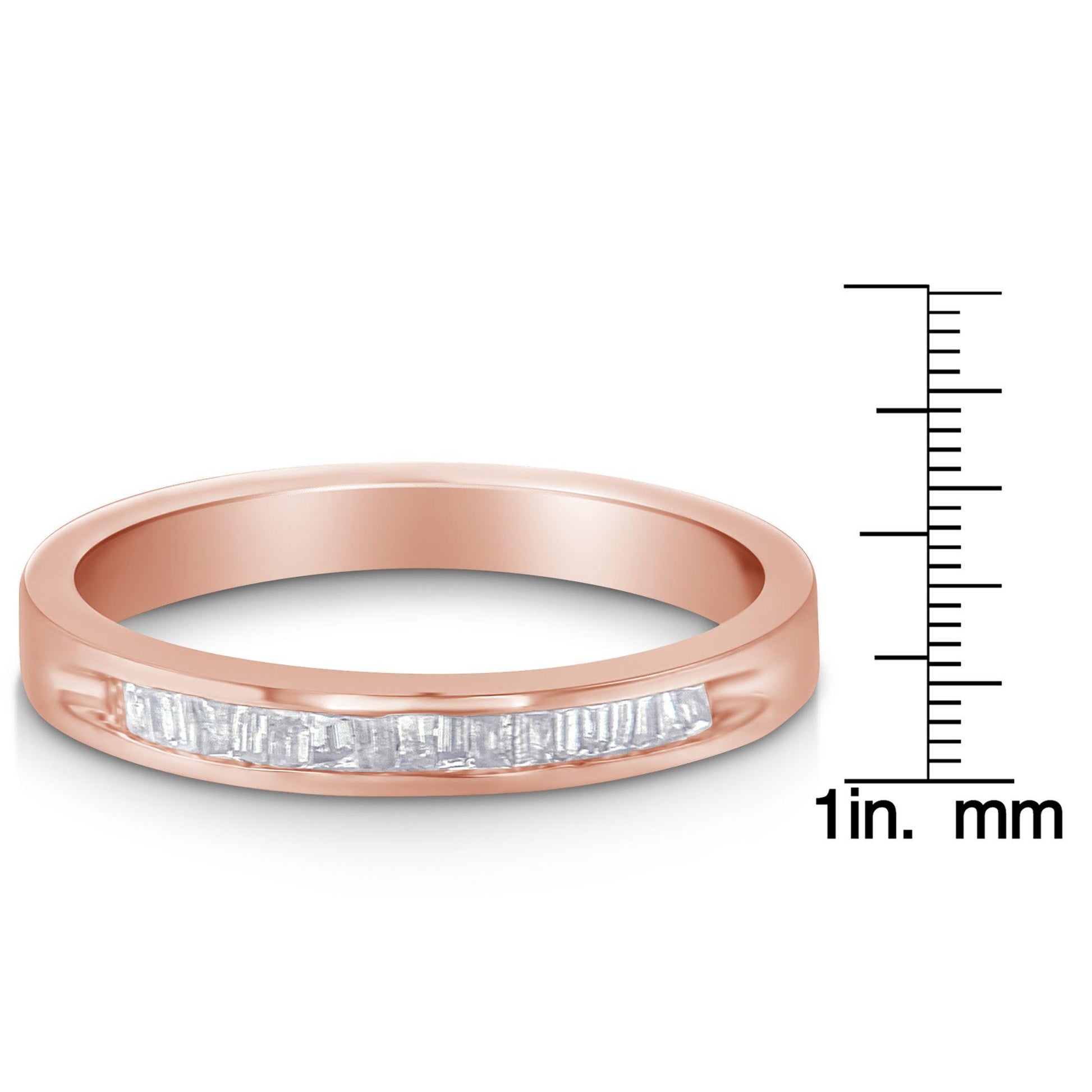 Rose metal ring with a channel setting of white baguette-shaped gemstones, shown in a front angle view next to a ruler for size reference.