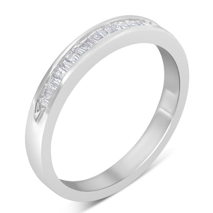 White metal ring with a channel set row of baguette-shaped white gemstones, shown at a slight angle.