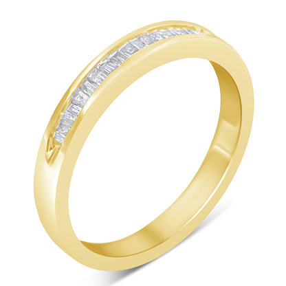 Yellow metal ring with a channel set row of white baguette-shaped gemstones, shown at an angled top-down view.