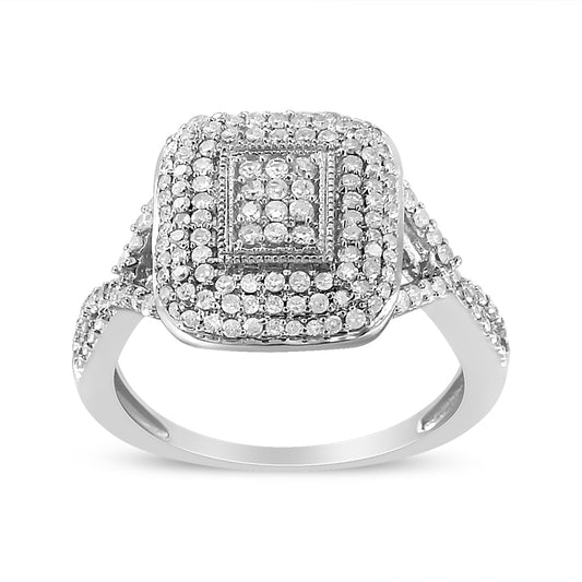 Front angle of a white metal ring featuring a square cluster of round white gemstones in prong settings, with additional gemstones adorning the band.