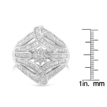 White metal ring with a central cluster of round white gemstones in prong setting, surrounded by curved bands of channel-set baguette white gemstones, shown from a front angled view, placed next to a ruler for size reference.