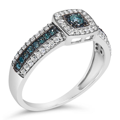 White metal ring with a central blue gemstone in a prong setting, surrounded by white gemstones, additional rows of blue and white gemstones on the band, shown at a slight angled side view.