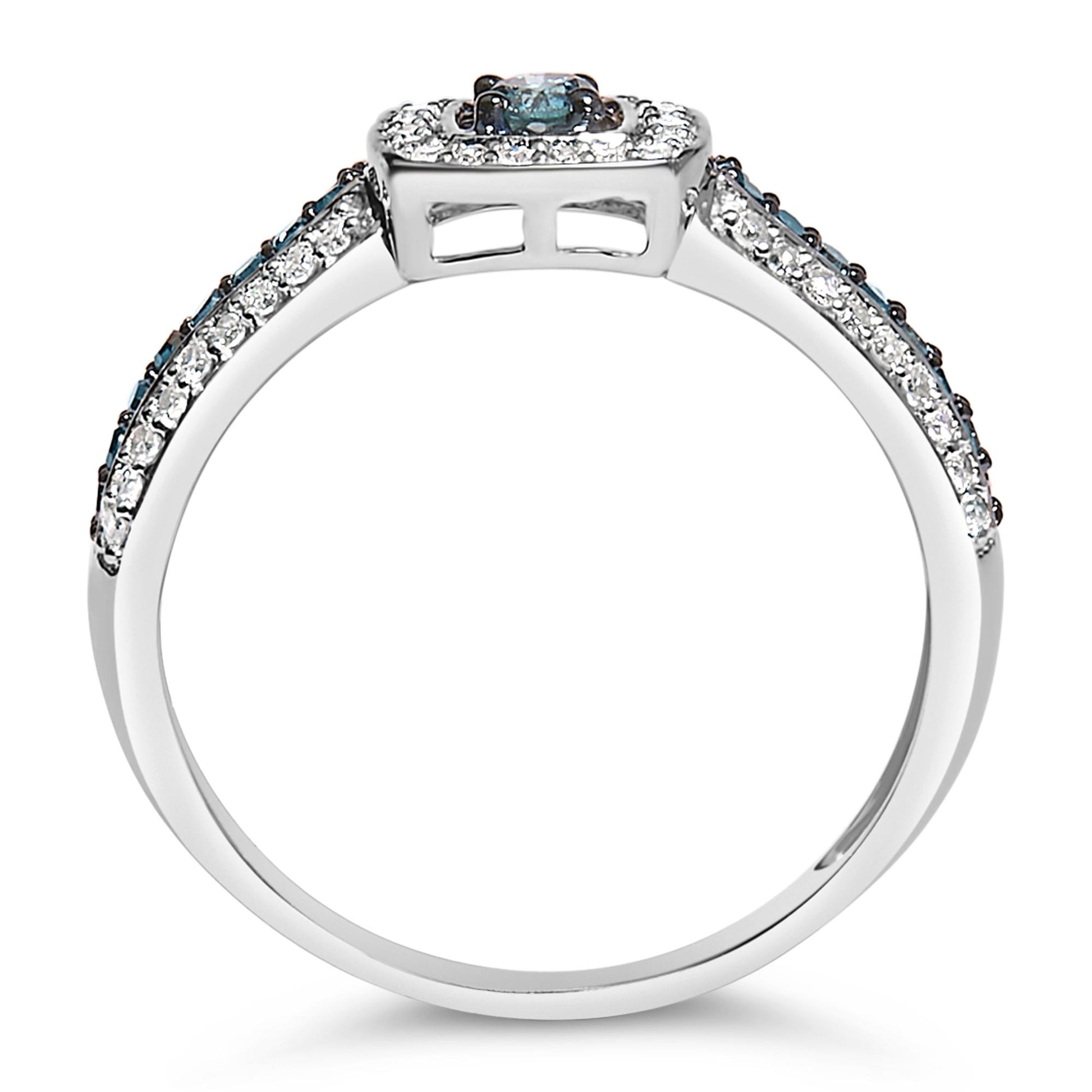 White metal ring with a central blue gemstone and smaller blue and white gemstones on the band, shown from a side angle on a white background.