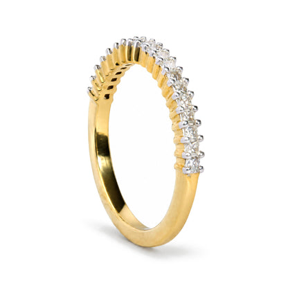 Close-up of a yellow ring with princess shaped white gemstones in prong settings, shown at a slight angle.