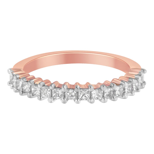 Close-up front angle of a rose-colored ring featuring a row of princess-shaped white gemstones in prong settings.