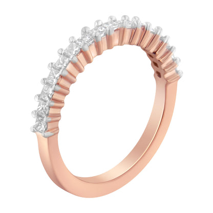 Close-up angled shot of a rose-colored ring featuring a row of white princess-cut gemstones in prong settings along the band.