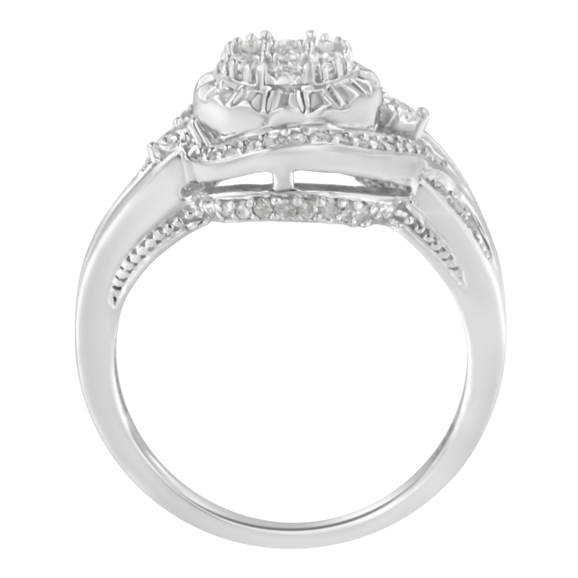 White metal ring with a cluster of round white gemstones in prong settings on top, viewed from the side angle.