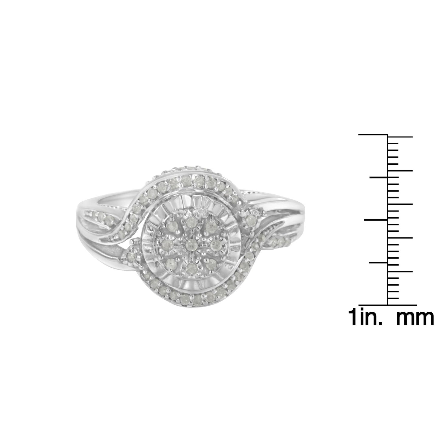 Front view of a white metal ring with a swirl design and round white gemstones in prong settings, displayed next to a ruler for size reference.