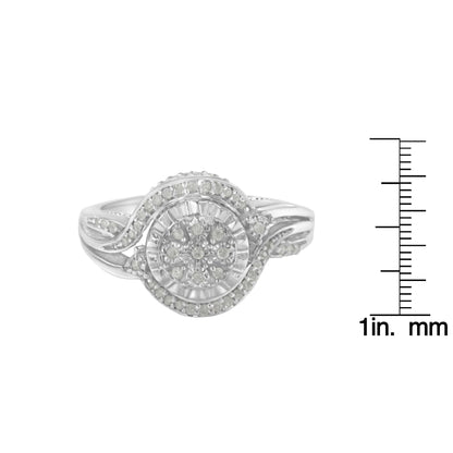 Front view of a white metal ring with a swirl design and round white gemstones in prong settings, displayed next to a ruler for size reference.