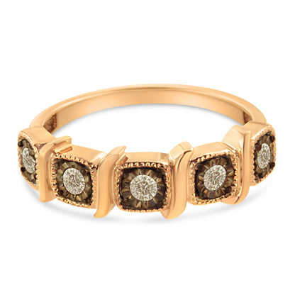 Close-up front angle of a rose-colored ring featuring five round white gemstones set in square black settings with surrounding decorative details.