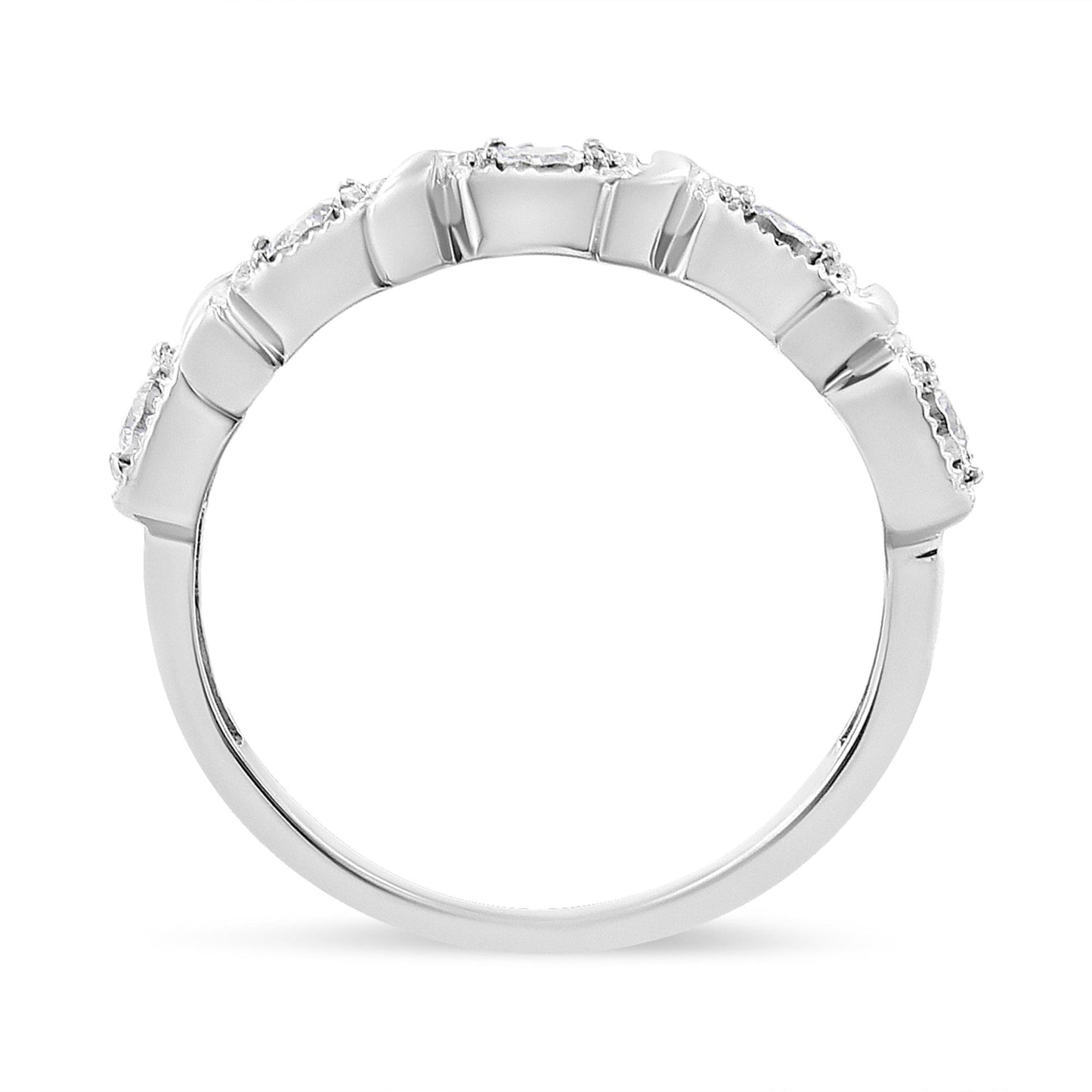 Close-up side view of a white metal ring featuring five round white gemstones set in a miracle setting along the top band.