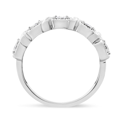 Close-up side view of a white metal ring featuring five round white gemstones set in a miracle setting along the top band.