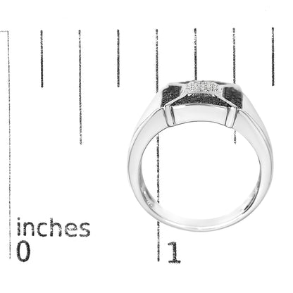 White metal ring with round black and white gemstones in pave setting viewed from front, placed on a ruler for size reference.