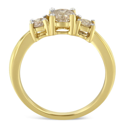 Close-up front angle of a yellow metal ring featuring one larger round white gemstone and two smaller round white gemstones in prong settings.