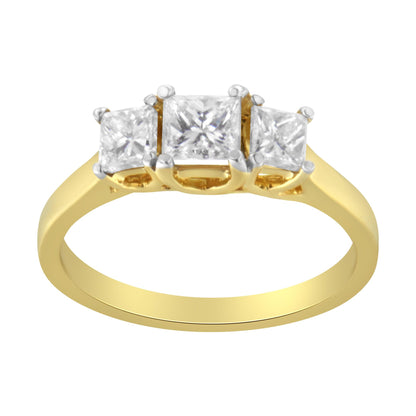 Front-facing yellow metal ring with three princess-shaped white gemstones in prong settings, shown against a white background.