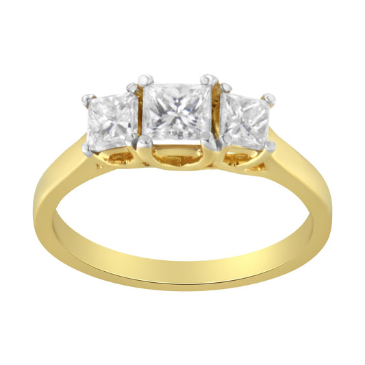Front-facing yellow metal ring with three princess-shaped white gemstones in prong settings, shown against a white background.