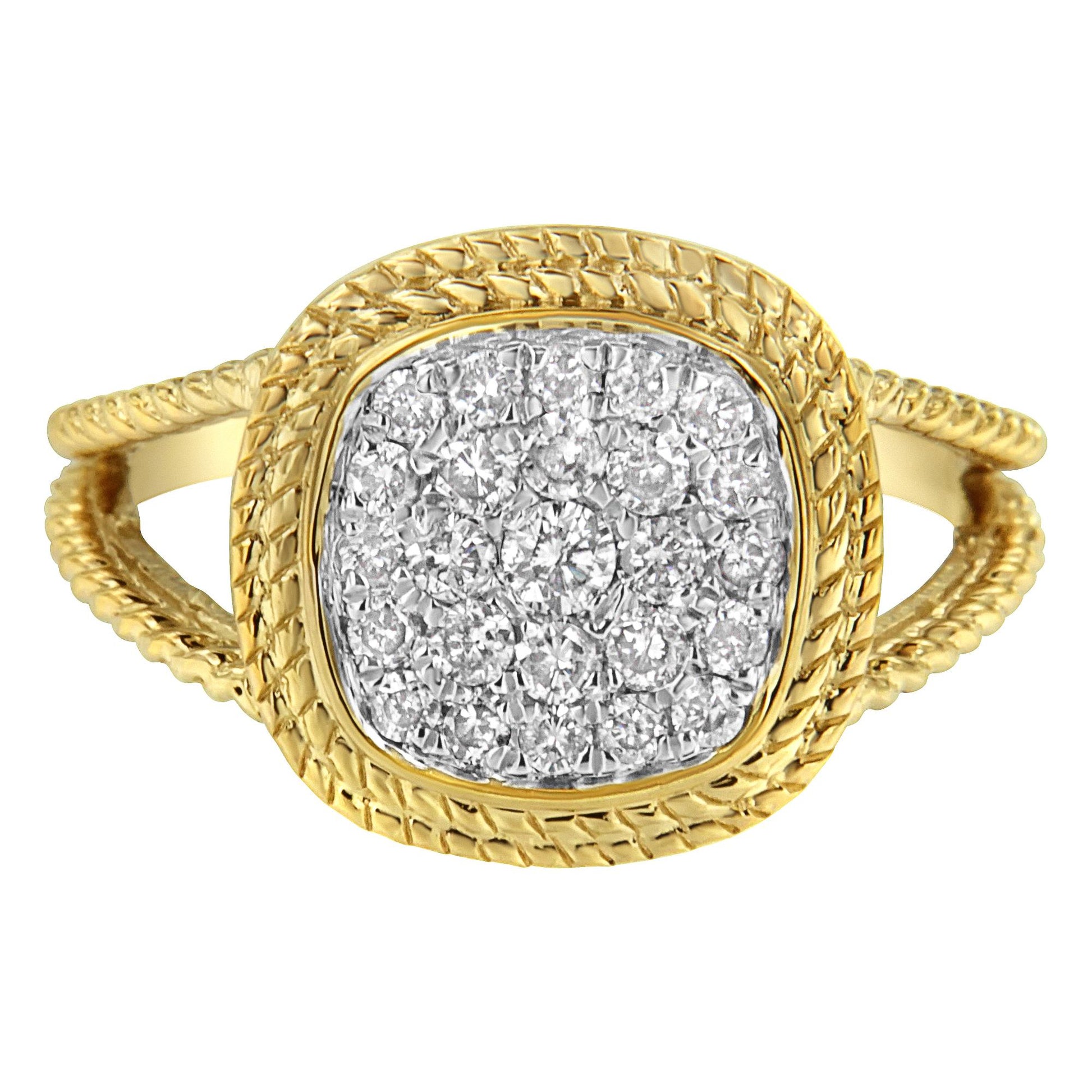 Front angle view of a yellow ring with a textured band and a cushion-shaped head set with multiple white round gemstones in a prong setting.