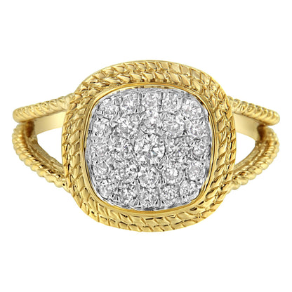 Front angle view of a yellow ring with a textured band and a cushion-shaped head set with multiple white round gemstones in a prong setting.