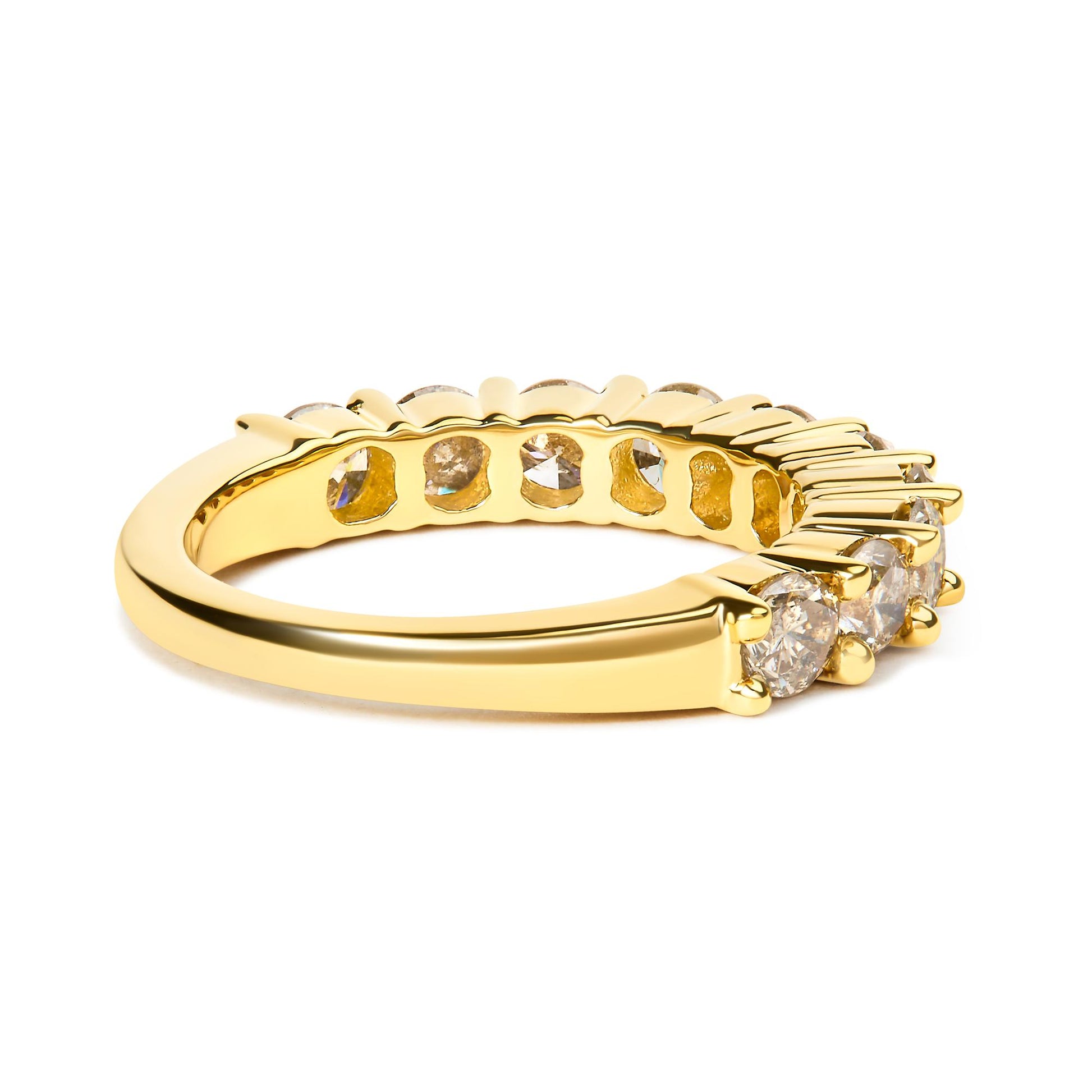 Yellow metal ring with round white gemstones in shared prong setting, shown from a side angle.