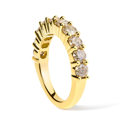 Yellow metal ring with round white gemstones in a shared prong setting, shown at a slight angle against a white background.