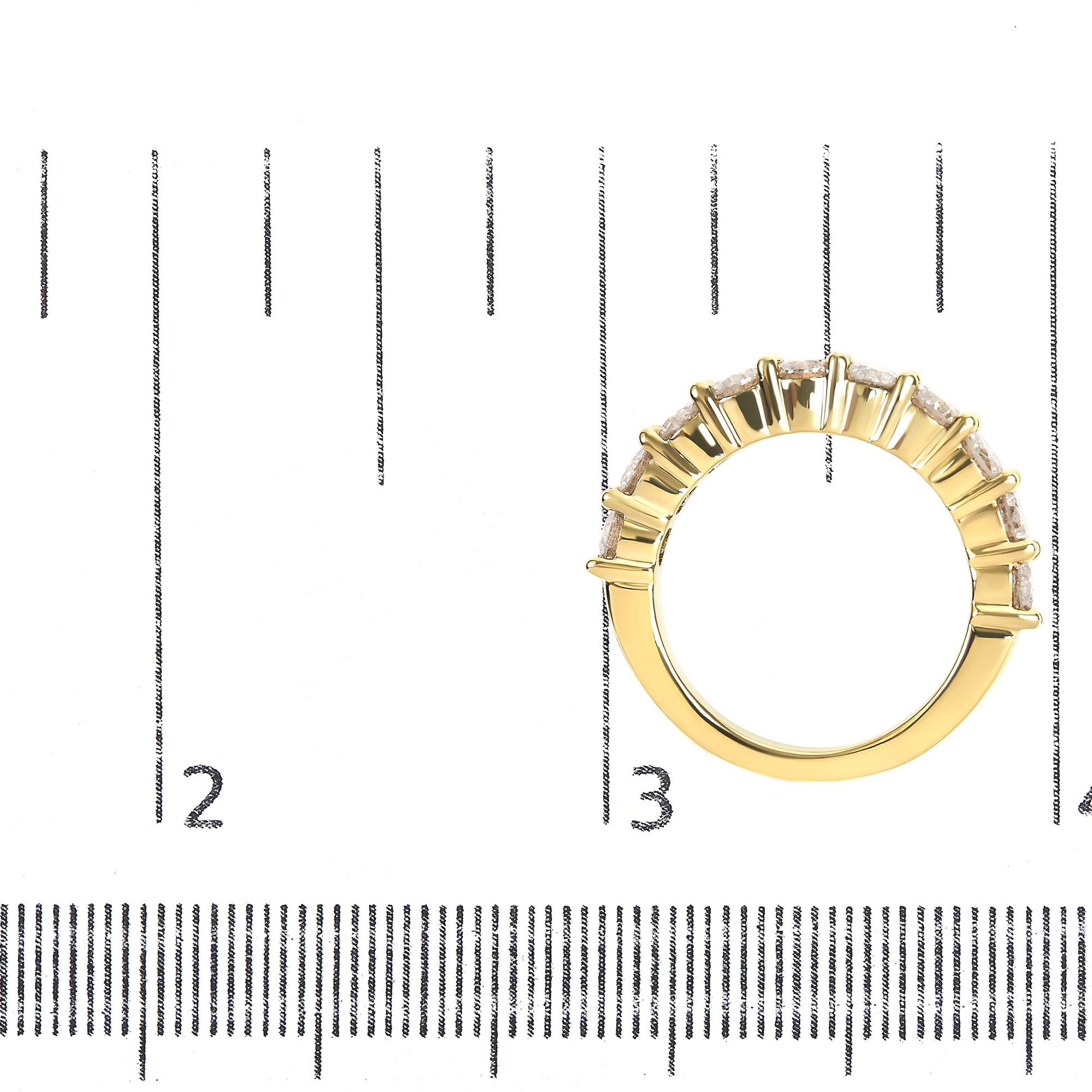 Top-down view of a yellow ring with round white gemstones in shared prong setting, placed on a ruler for size reference.