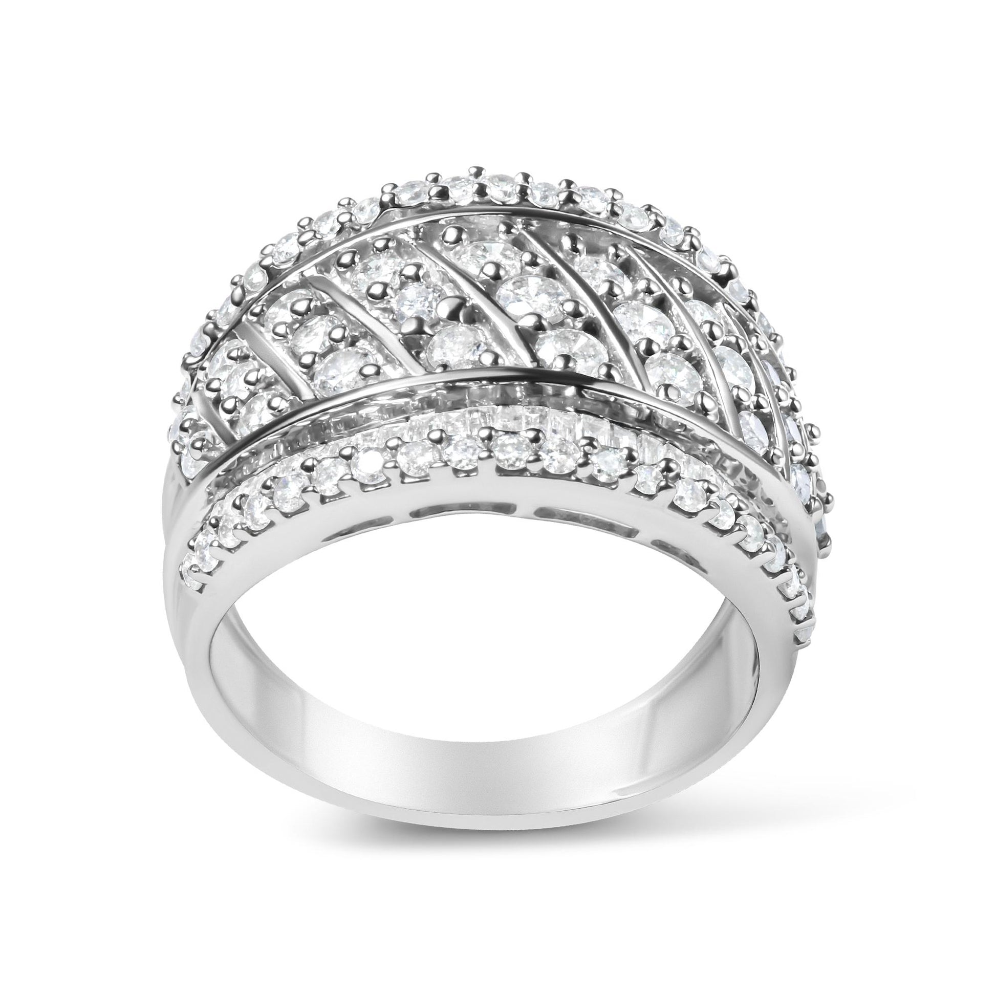 Front angled view of a white metal ring featuring rows of round white gemstones in prong settings and baguette-shaped white gemstones in channel settings.