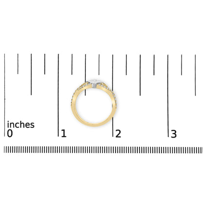 Top view of a two-tone ring with a princess-shaped gemstone in a channel setting flanked by multiple round gemstones in prong settings, placed on a ruler for size reference.