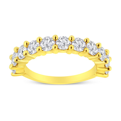 Yellow metal ring with round white gemstones in prong settings viewed from a side angle.