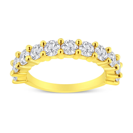 Yellow metal ring with round white gemstones in prong settings viewed from a side angle.