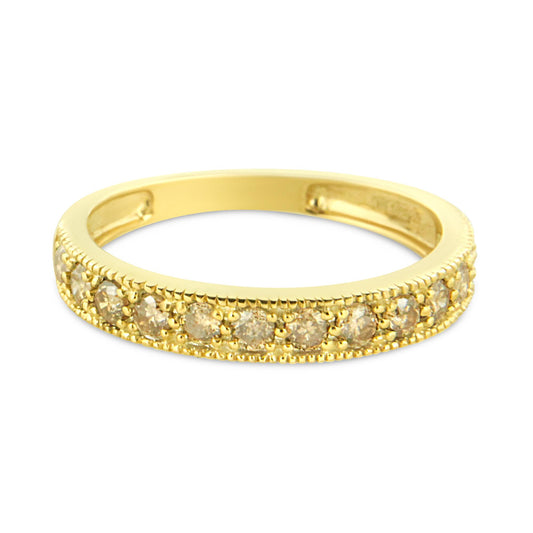 Yellow metal ring with round white gemstones set in pave style, viewed from a slight side angle.