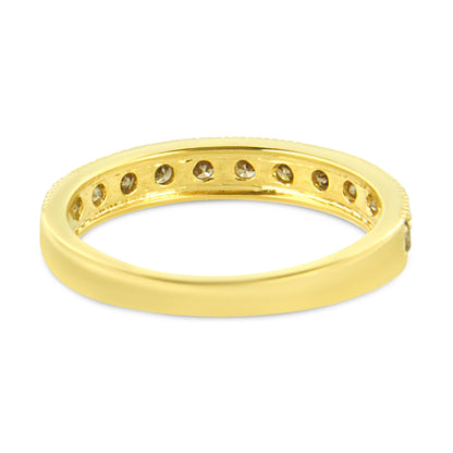Yellow metal ring with round white gemstones set in a pave style visible from an angled side view.